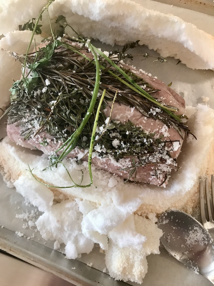 Roasted Pork Loin Topped With Herbs After Cooking and Salt Crust Is Opened