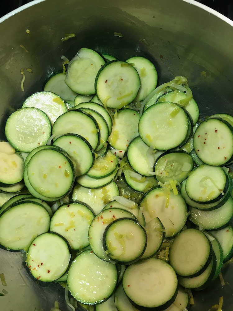 Sliced zucchini added to leeks and garlic